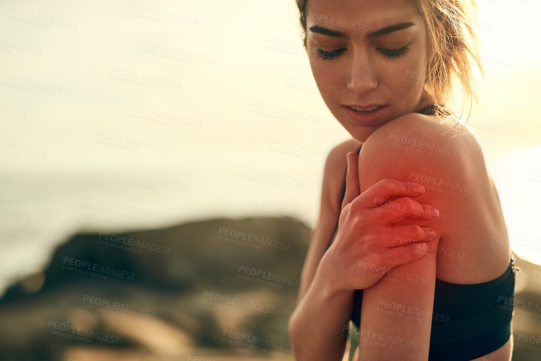 Buy stock photo Shot of a young sporty woman with a sports injury while out for a run