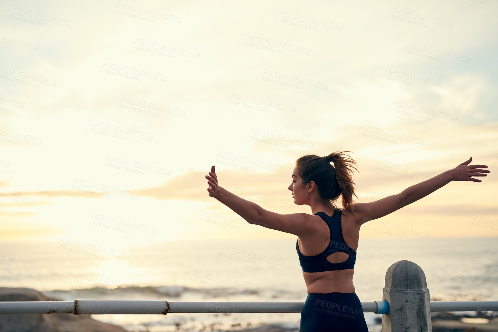 Buy stock photo Woman, arms in air and sunset at beach for fitness, exercise and freedom in summer. Celebration, runner and success in nature for workout, training and ocean with achievement for wellness and health