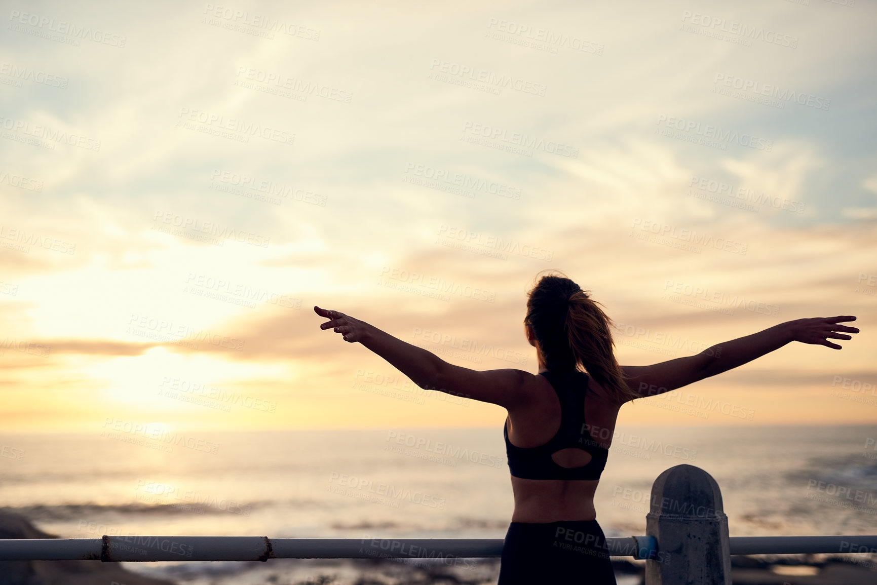 Buy stock photo Sunset, woman and arms in air at beach for fitness, exercise and freedom in summer. Female silhouette , celebration and runner in nature for workout, training and ocean with achievement for wellness