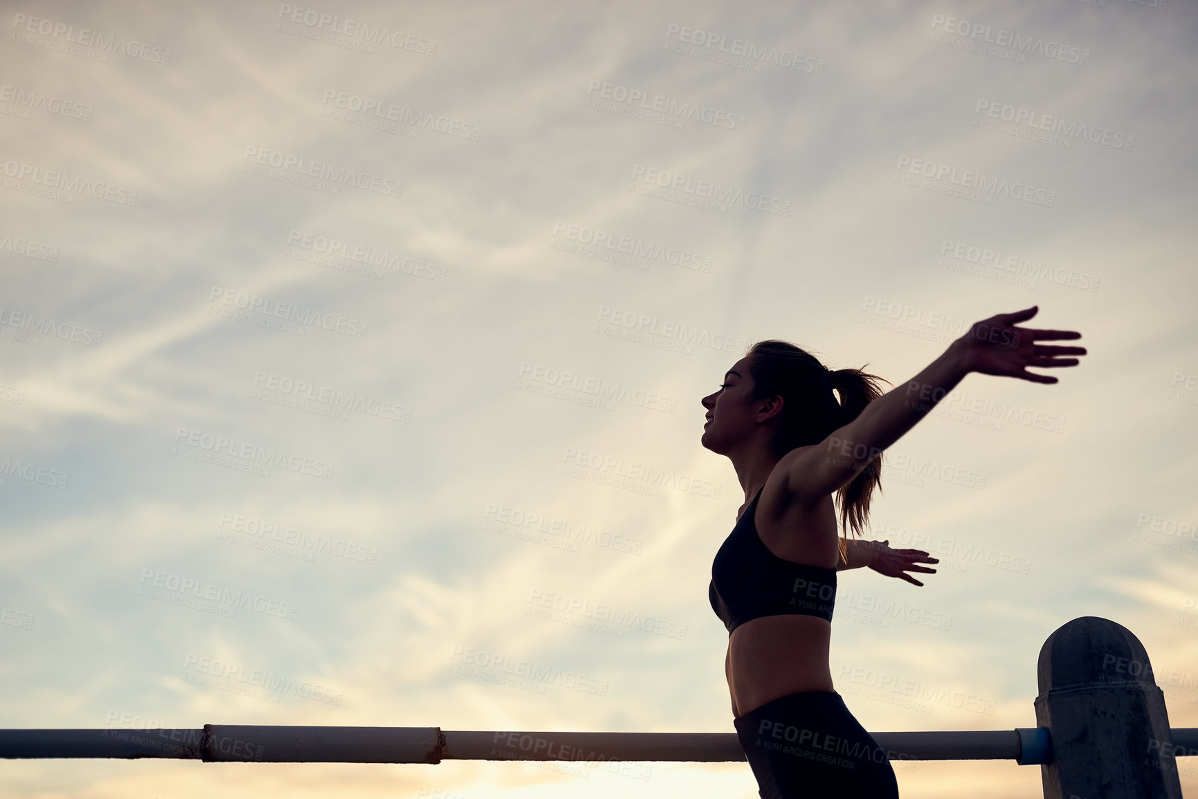 Buy stock photo Woman, silhouette and arms in air at beach for fitness, exercise and freedom in summer. Runner, celebration and female person in nature for workout, training and ocean with achievement for wellness