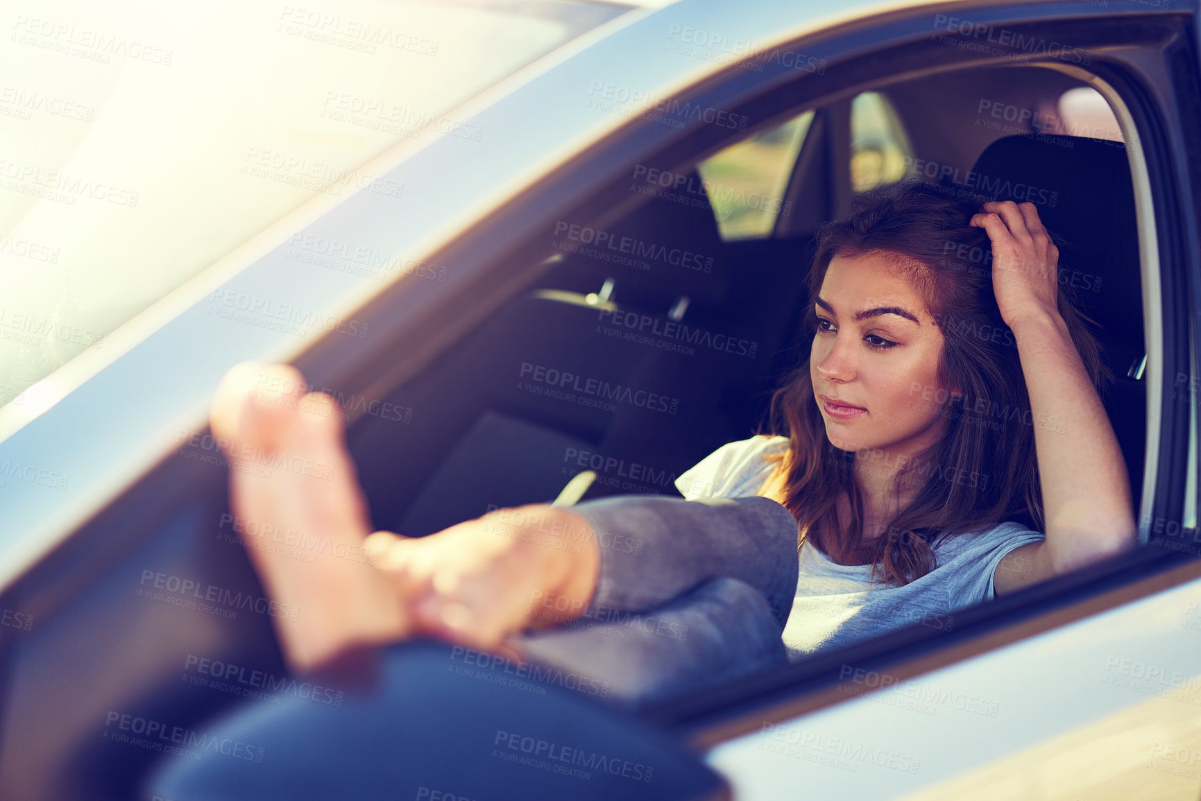 Buy stock photo Shot of a young woman sitting in her car