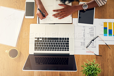 Buy stock photo High angle shot of an unrecognizable woman working on her laptop at home