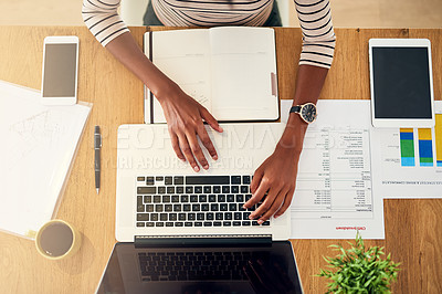 Buy stock photo High angle shot of an unrecognizable woman working on her laptop at home