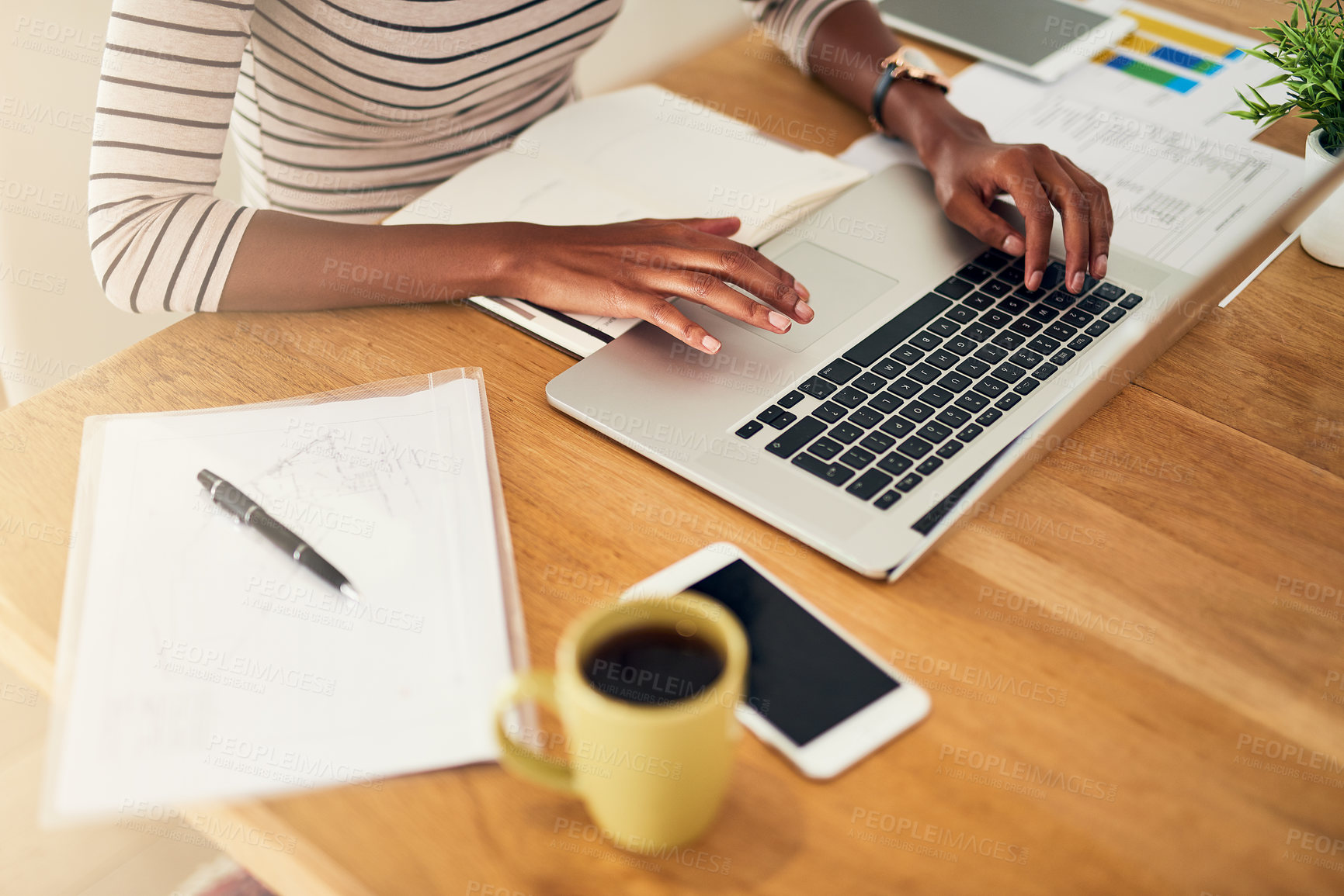 Buy stock photo Cropped shot of an unrecognizable woman working on her laptop at home