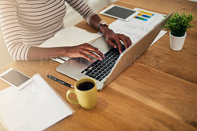Buy stock photo Cropped shot of an unrecognizable woman working on her laptop at home