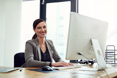 Buy stock photo Portrait of a young businesswoman working on a computer in an office