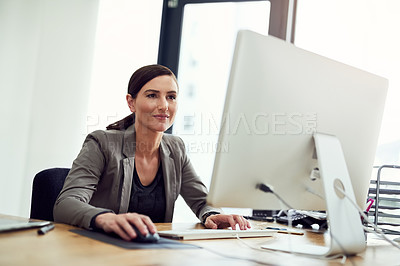 Buy stock photo Cropped shot of a young businesswoman working on a computer in an office