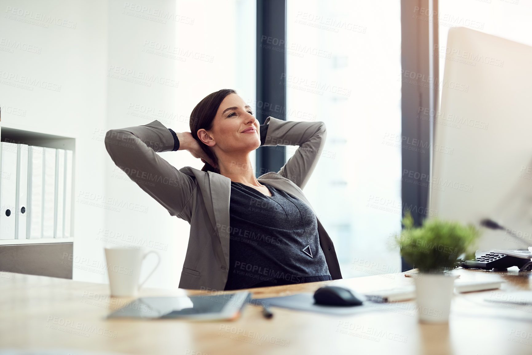 Buy stock photo Cropped shot of a young businesswoman taking a break at her desk