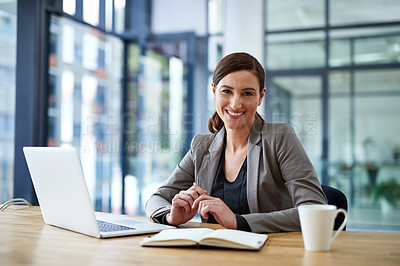 Buy stock photo Portrait of a young woman working on a laptop in an office