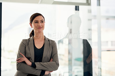 Buy stock photo Cropped shot of a confident young businesswoman standing in an office