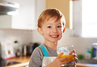 Buy stock photo Portrait of a young boy drinking a glass of juice at home