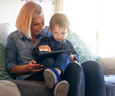 Buy stock photo Cropped shot of a mother and son using a digital tablet together at home