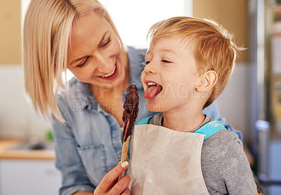 Buy stock photo Mother, boy and spoon with chocolate in kitchen for baking, learning and development in family home. Parent, kid and taste with sweet in house for brownies, bonding with lick or cooking with youth