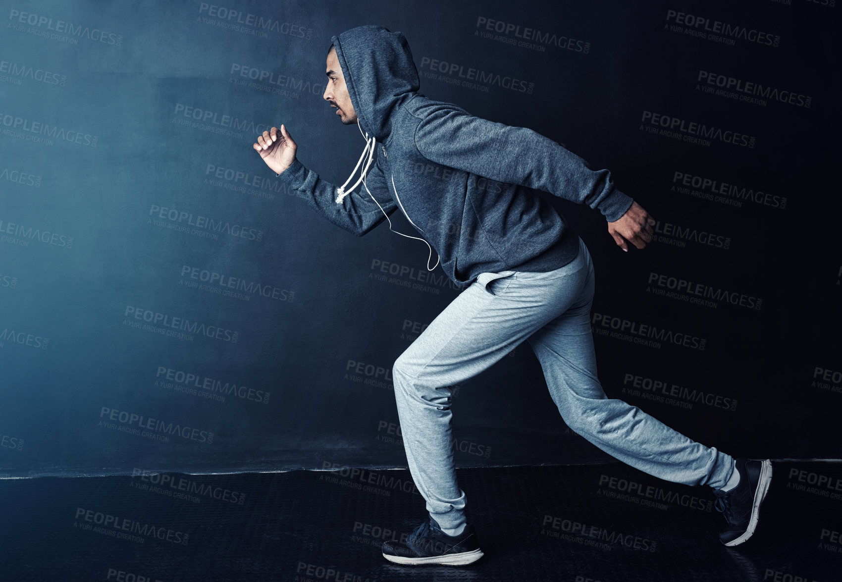 Buy stock photo Running, speed and profile of man in studio with confidence, hoodie and challenge at gym workout. Fitness, marathon training and runner with sportswear, commitment and exercise on dark background