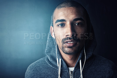 Buy stock photo Studio portrait of a sporty young man standing against a dark background