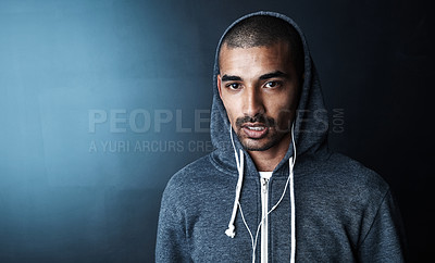 Buy stock photo Studio portrait of a sporty young man standing against a dark background