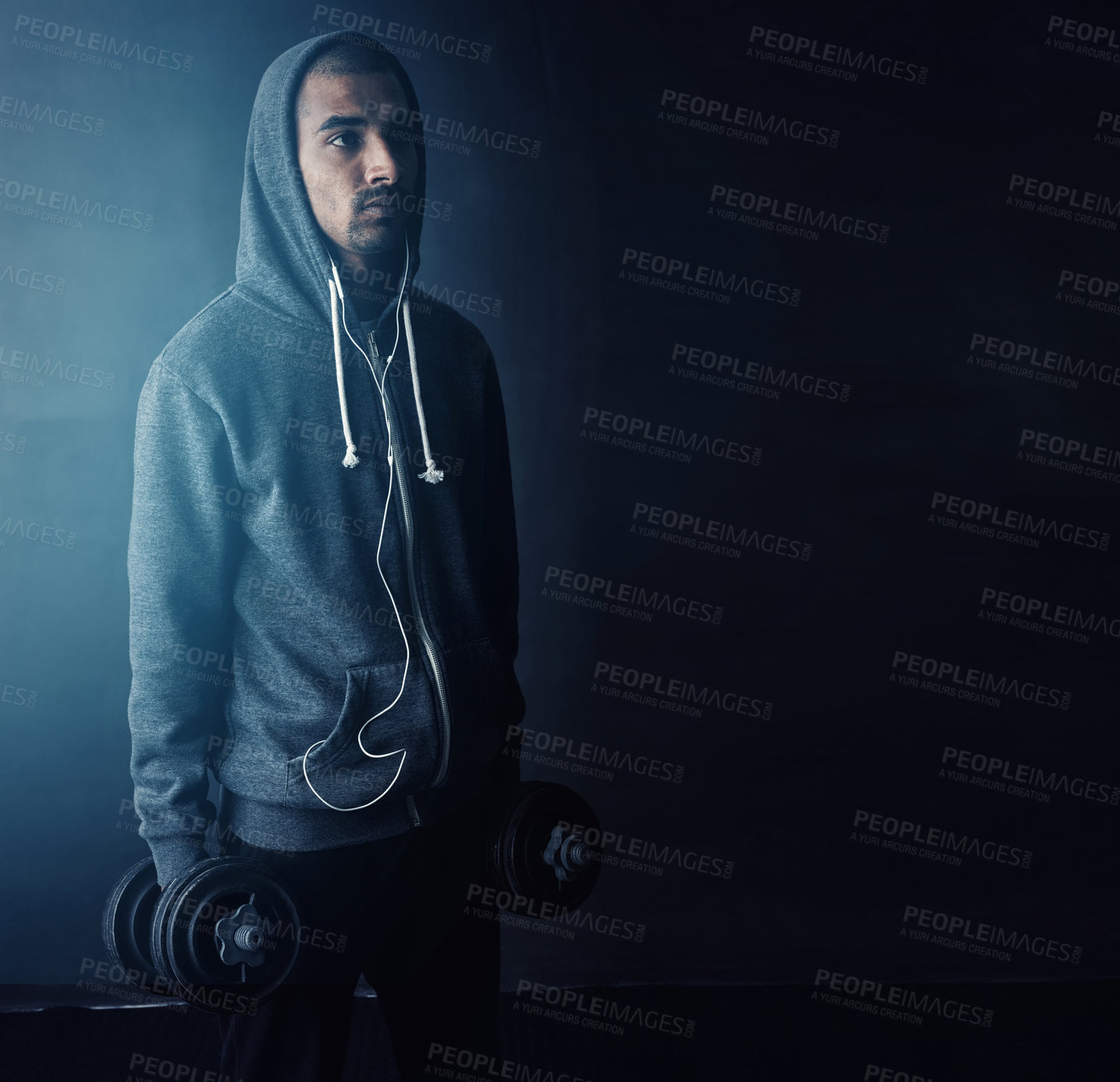 Buy stock photo Studio shot of a young man working out against a dark background