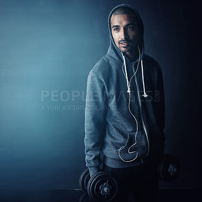 Buy stock photo Man, dumbbells and earphones for fitness in studio, muscle and mock up space by dark background. Person, bodybuilder and happy with streaming subscription for training, workout or exercise for growth