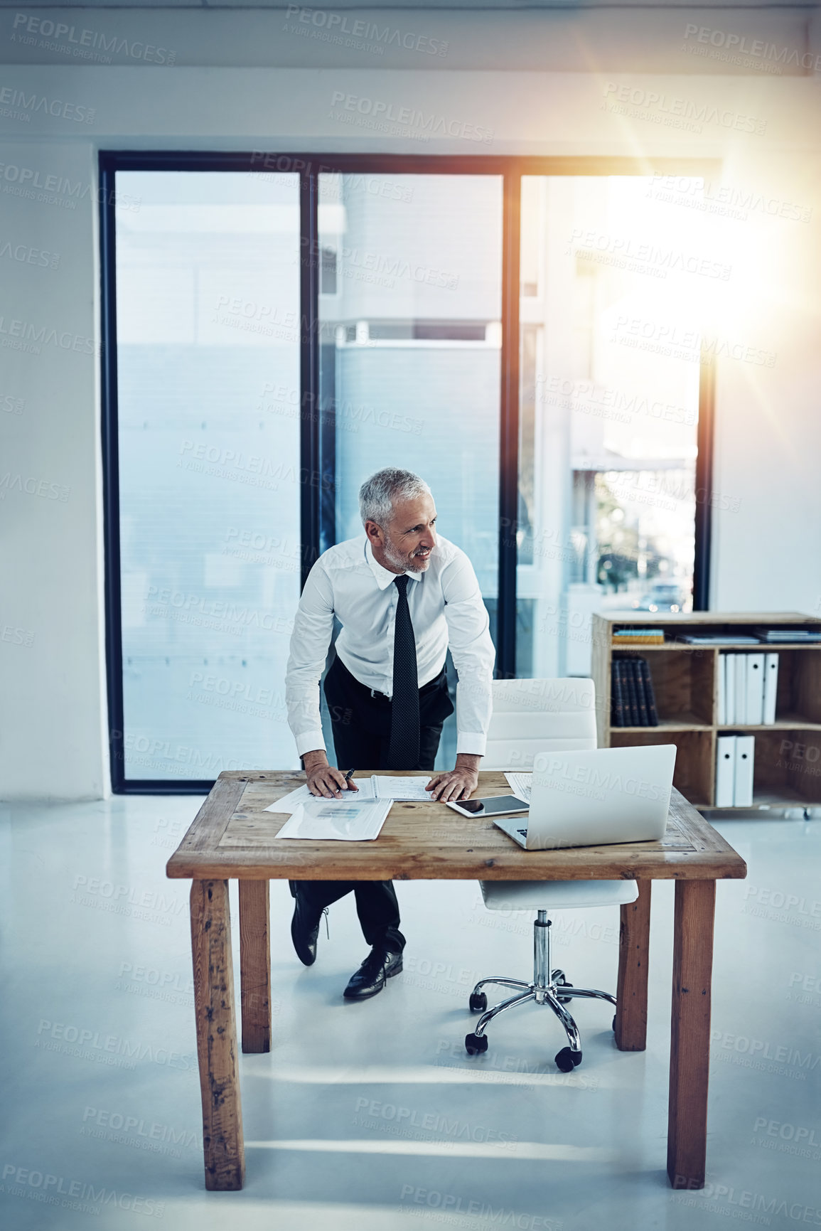 Buy stock photo Shot of a businessman working at his desk in an office