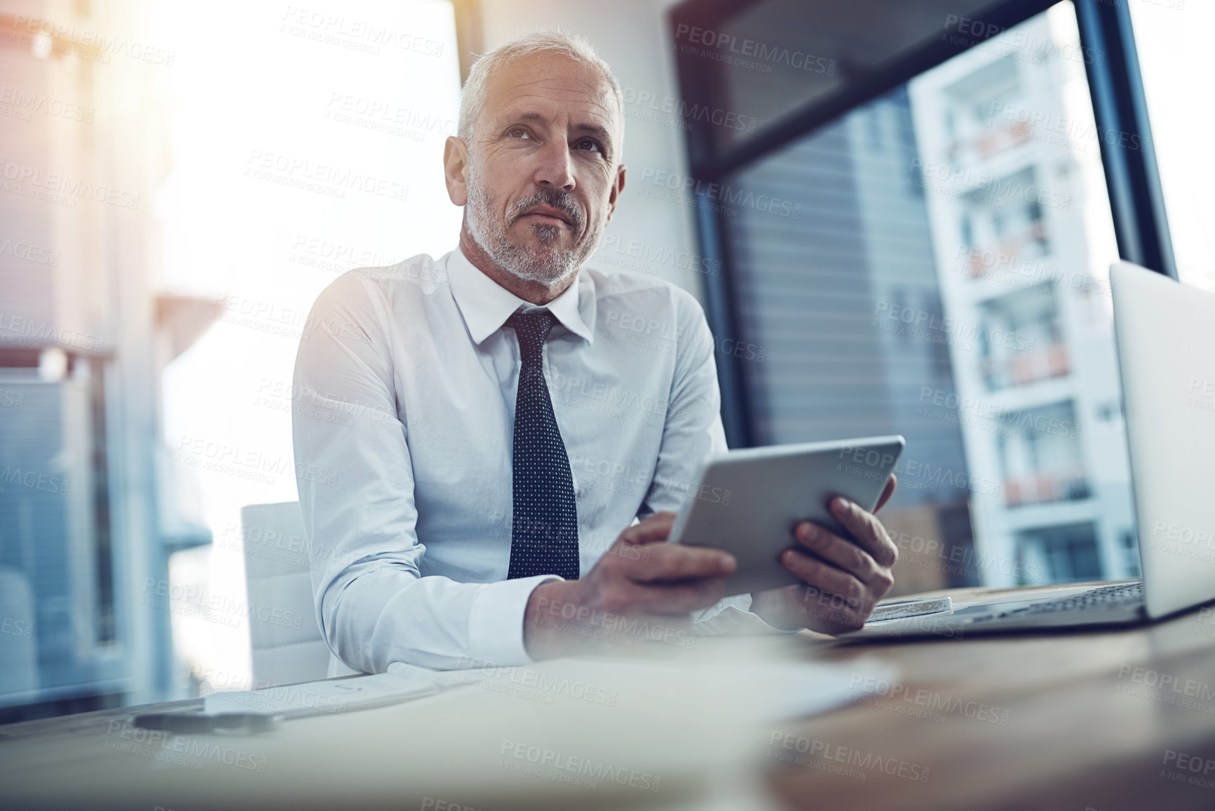 Buy stock photo Mature, businessman and thinking with tablet in office as accountant in financial agency or banking. Male person, technology and planning at desk for investment opportunity, career or idea as manager