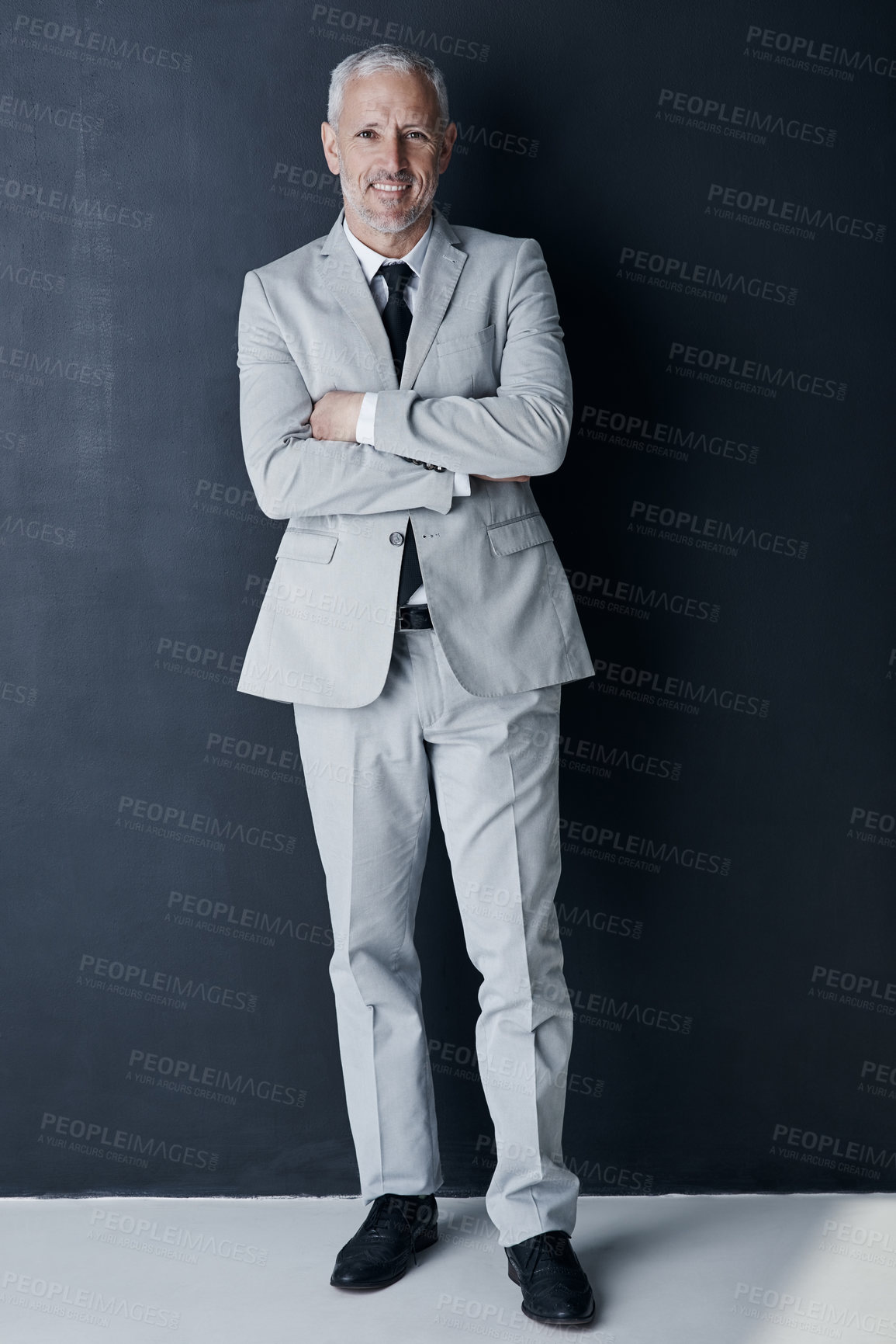 Buy stock photo Studio portrait of mature man in suit, arms crossed and smile on dark background. Confidence, pride and professional career for happy executive businessman or senior business owner or successful ceo.