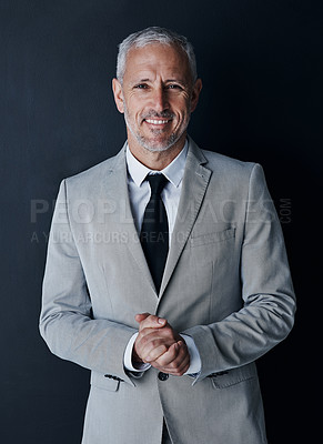 Buy stock photo Studio portrait of senior businessman in suit, smile and handsome face on dark background. Confidence, pride and professional career for happy executive man or mature business owner or successful ceo