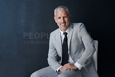 Buy stock photo Studio portrait, happy businessman and chair in mockup space with confident boss on dark background. Smile, pride and professional career for executive, mature startup business owner or startup ceo.