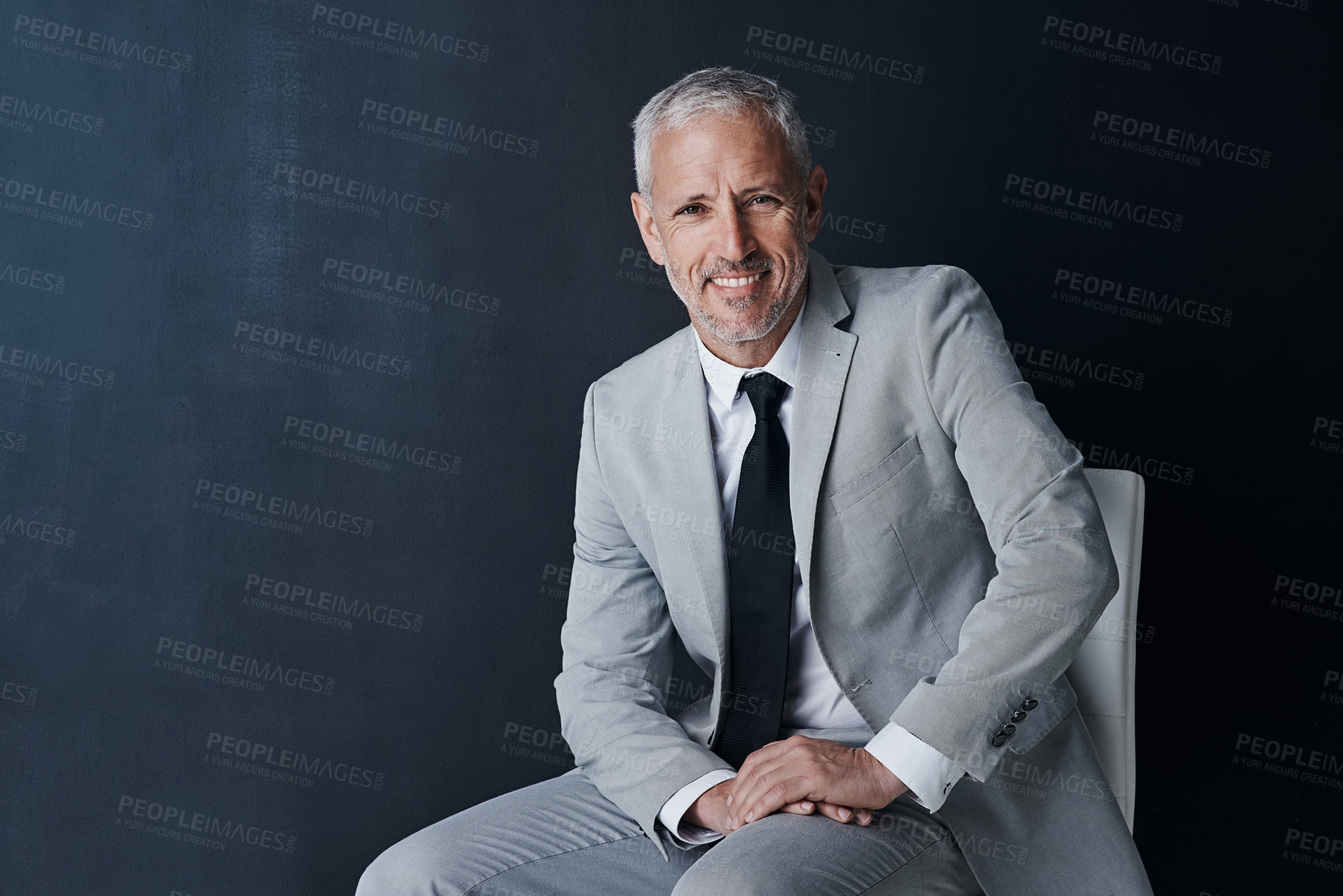 Buy stock photo Studio portrait, happy businessman and chair in mockup space with confident boss on dark background. Smile, pride and professional career for executive, mature startup business owner or startup ceo.