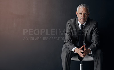 Buy stock photo Mock up, chair and serious portrait of lawyer, attorney or businessman with confidence on dark background in studio space. Boss, ceo or business owner, proud senior executive director at law firm.