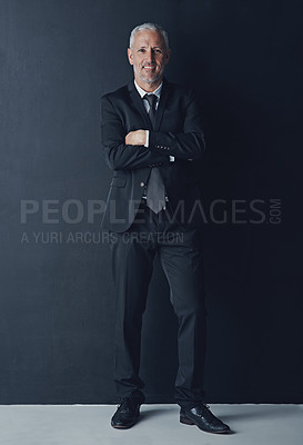 Buy stock photo Studio portrait of mature businessman in suit, arms crossed and smile on dark background. Confidence, pride and professional career for happy executive man or senior business owner or successful ceo