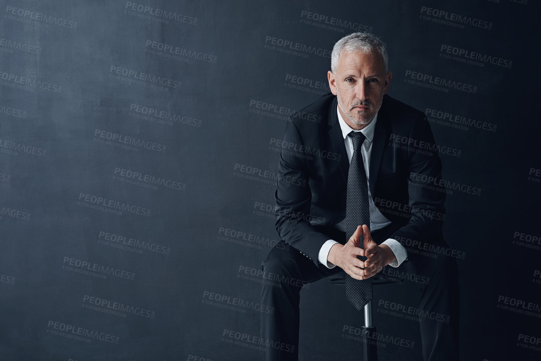 Buy stock photo Studio portrait of a mature businessman against a dark background