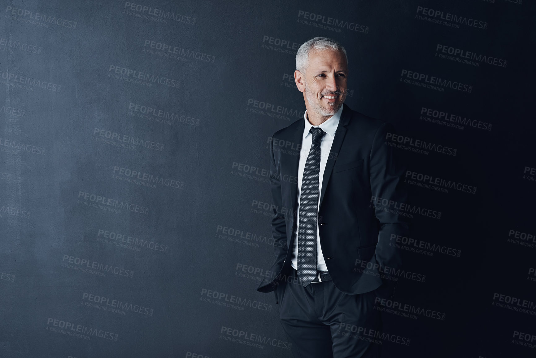Buy stock photo Studio shot of a mature businessman against a dark background