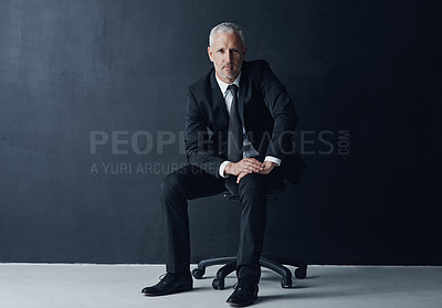 Buy stock photo Studio portrait of a mature businessman against a dark background