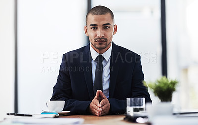 Buy stock photo Portrait of a young businessmen working at his desk in a modern office