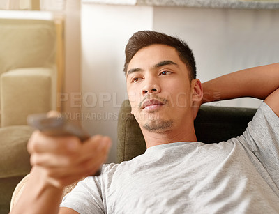 Buy stock photo Movie, relax and man with remote of sofa for streaming service, subscription and watching tv at home. Calm, and male person with control in living room for series, entertainment and broadcast of news