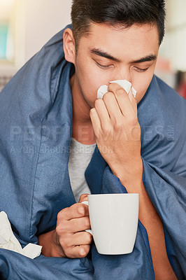 Buy stock photo Shot of a young man with a cold recuperating at home