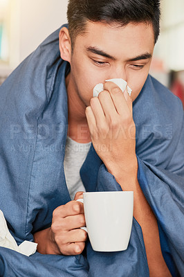 Buy stock photo Shot of a young man with a cold recuperating at home