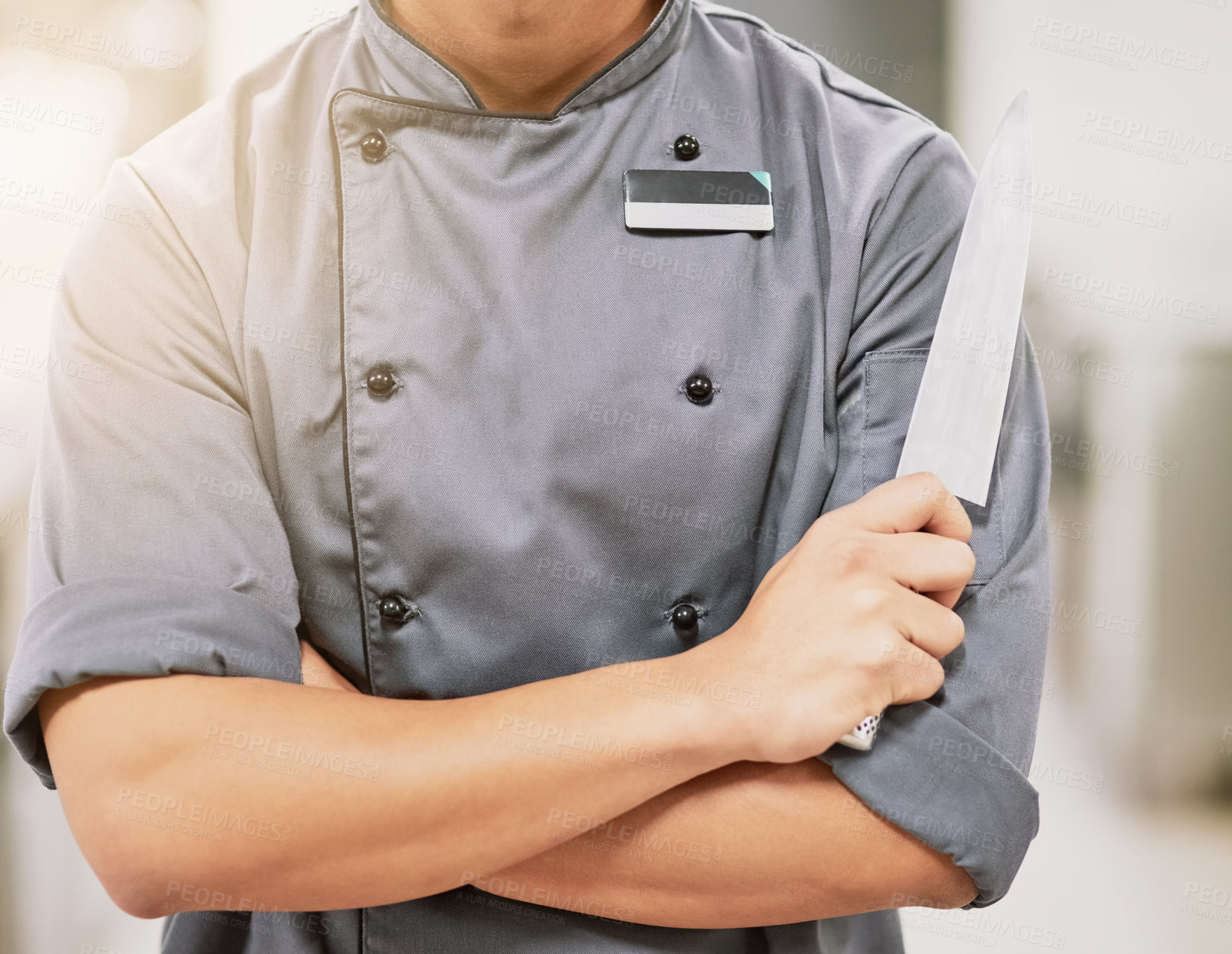 Buy stock photo Arms crossed, chef and person with knife in kitchen for food, catering industry and fine dining for hotel. Nutritionist or hospitality worker, confidence and tools for cooking with restaurant launch