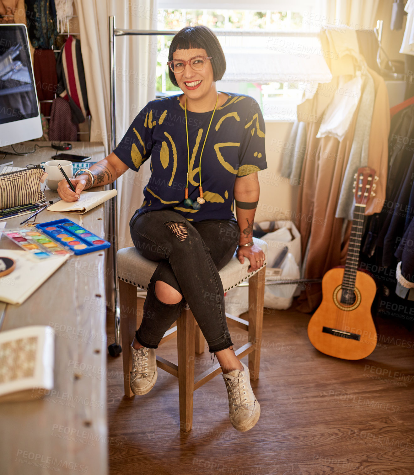 Buy stock photo Portrait of a stylish young designer sitting in her eclectic studio