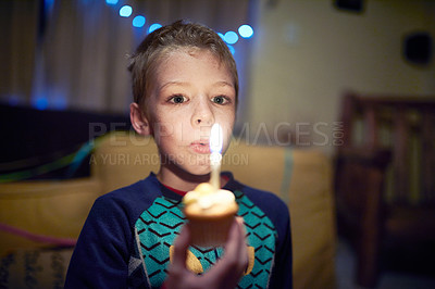 Buy stock photo Shot of a little boy celebrating his birthday at night time