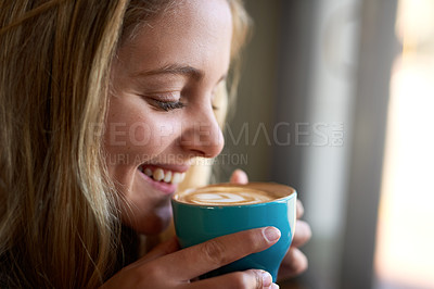 Buy stock photo Closeup shot of an attractive young woman enjoying a cappuccino in a coffee shop