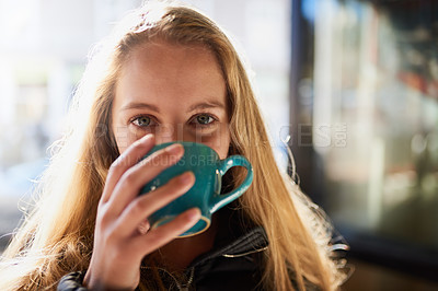 Buy stock photo Portrait of an attractive young woman enjoying a cappuccino in a coffee shop