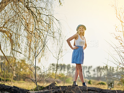 Buy stock photo Happy, woman and tree stump in nature for peace, wellness and rest on vacation or holiday. Excited, person and smile for environment to relax on spring break with walk in countryside and fields