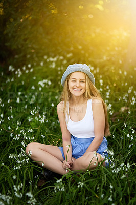Buy stock photo Girl, portrait and fashion in field of flowers, travel and spring or grass for casual style in garden. Female person, relax and countryside holiday or vacation, aesthetic and clothes in nature meadow