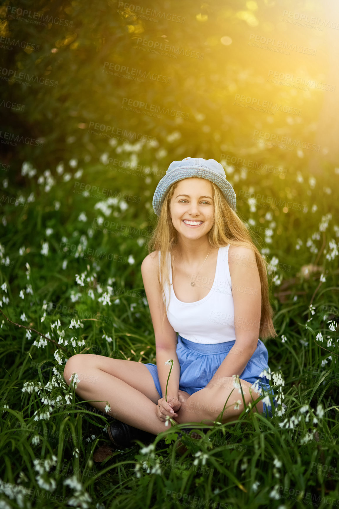 Buy stock photo Girl, portrait and fashion in field of flowers, travel and spring or grass for casual style in garden. Female person, relax and countryside holiday or vacation, aesthetic and clothes in nature meadow