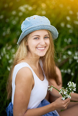 Buy stock photo Girl, portrait and relax in field of flowers, travel and spring or plants for wellness in garden. Female person, park and countryside holiday or vacation, aesthetic and environment in nature meadow