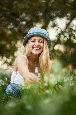 Buy stock photo Girl, smile and outdoor, nature and flowers, park and grass lawn for plants, spring and garden. Field, happy and explore in countryside, meadow and botanical for summer, green and holiday or travel