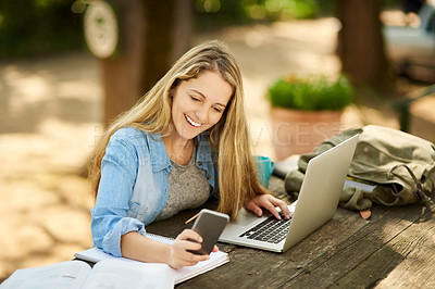 Buy stock photo Shot of a young woman studying outdoors