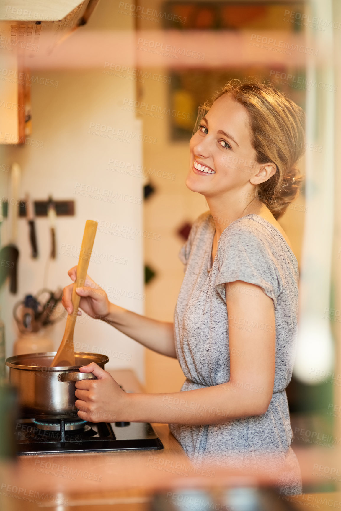 Buy stock photo Portrait of an attractive young woman cooking at home