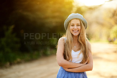 Buy stock photo Shot of a young woman on a tree stump out in the countryside